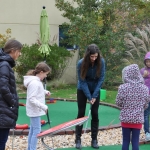Victoria and Sophie playing golf with the students