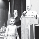 Head of the Parent Commitee Vytas Maciulis with his daughter Olivija and member of the Comittee Ausra Baron present prizes to the lottery winners