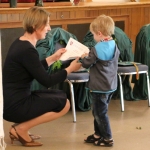 Young student Jokubas receives his certificate for stepping into the world of Lithuanian Language